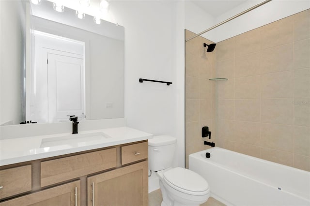 full bathroom with toilet, vanity, and tiled shower / bath