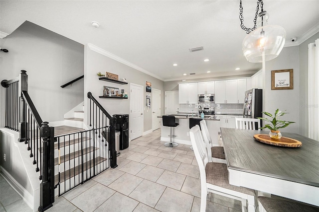 dining space with ornamental molding