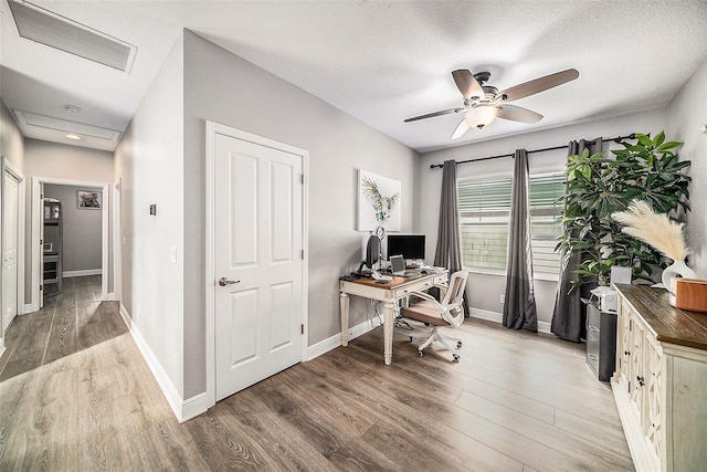 office featuring ceiling fan, hardwood / wood-style floors, and a textured ceiling