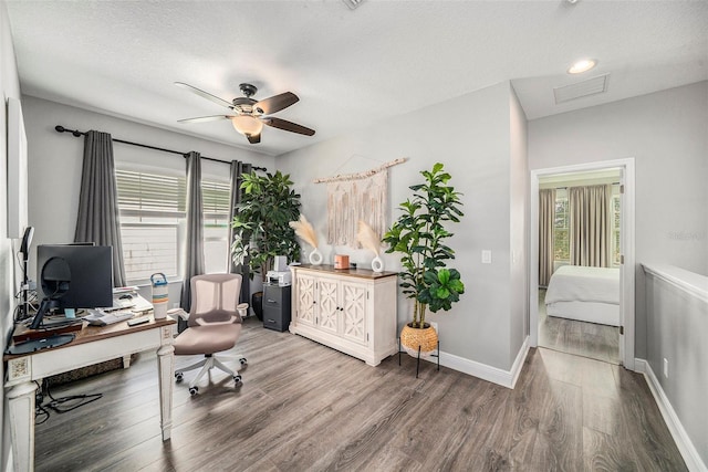 office space featuring a healthy amount of sunlight, a textured ceiling, and wood-type flooring