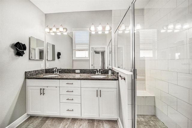 bathroom featuring hardwood / wood-style floors, vanity, and walk in shower