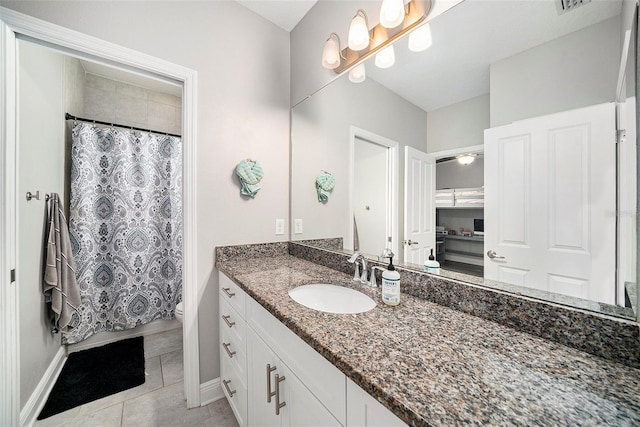 bathroom featuring toilet, a shower with curtain, vanity, and tile patterned floors