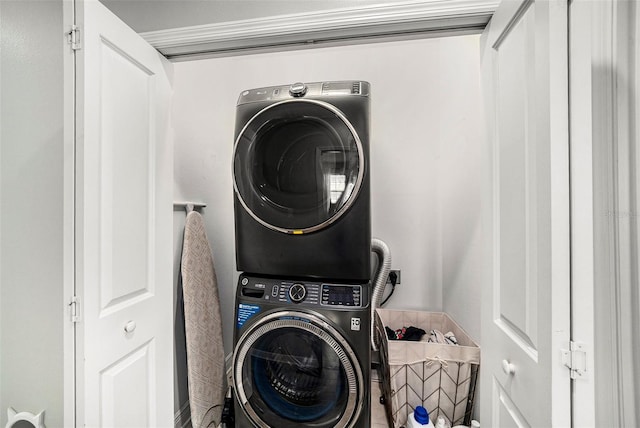 laundry area featuring stacked washer and clothes dryer