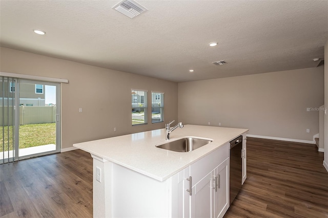 kitchen featuring a kitchen island with sink, sink, dark wood-type flooring, and plenty of natural light