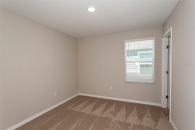 unfurnished room featuring carpet floors and a textured ceiling