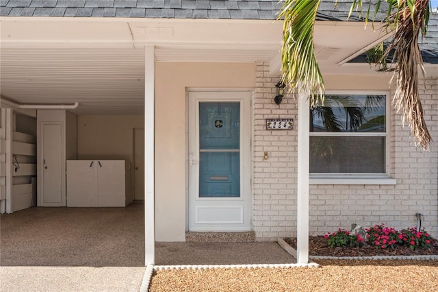 view of exterior entry featuring a carport