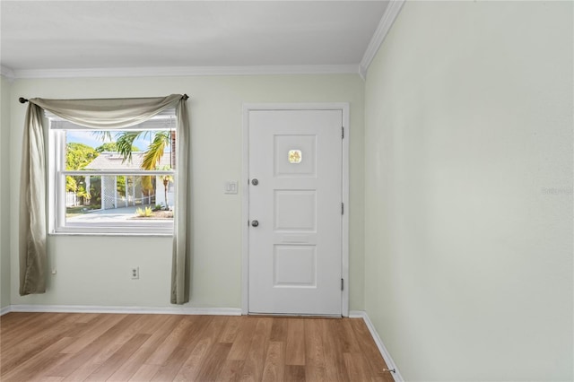 doorway with crown molding and light hardwood / wood-style flooring