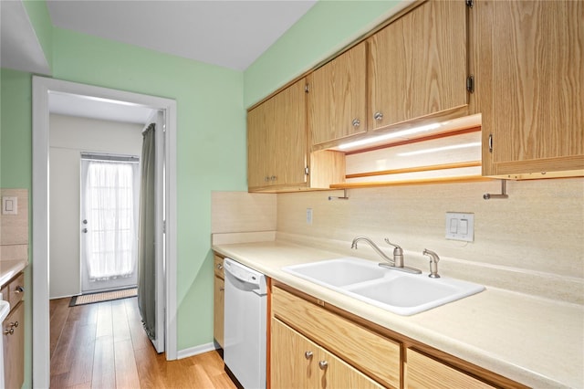 kitchen with sink, light hardwood / wood-style floors, and dishwasher