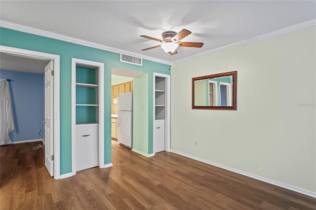 unfurnished bedroom featuring ceiling fan, white refrigerator, ornamental molding, and hardwood / wood-style floors