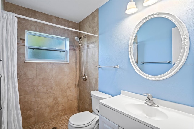 bathroom with toilet, a shower with shower curtain, and vanity