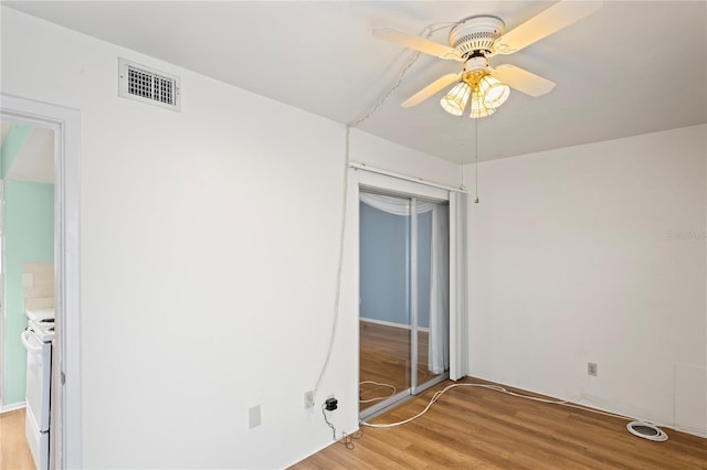 empty room with ceiling fan and light hardwood / wood-style floors