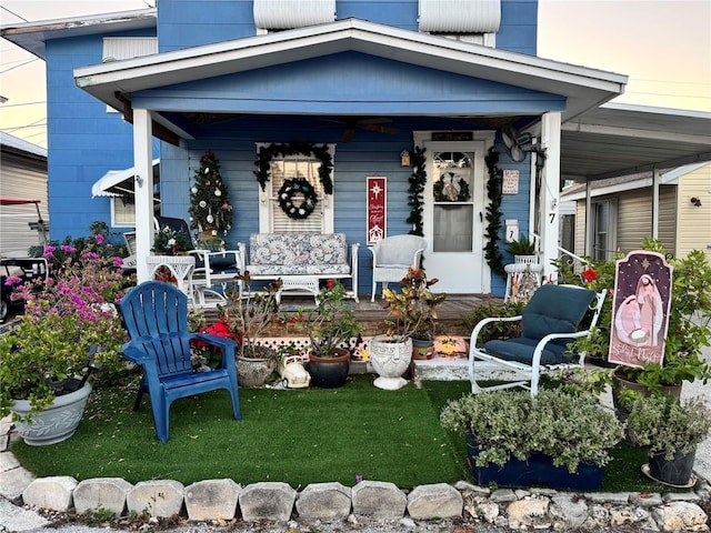 rear view of property featuring a porch