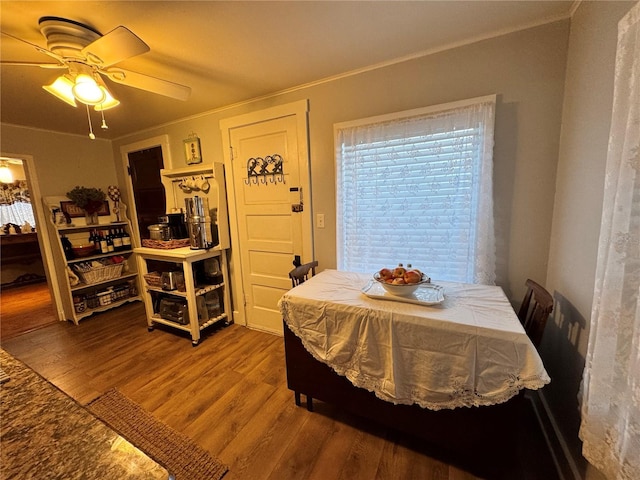 dining area with hardwood / wood-style floors, ceiling fan, and crown molding