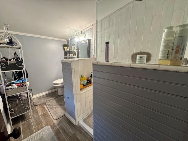 bathroom with crown molding, toilet, vanity, and hardwood / wood-style flooring