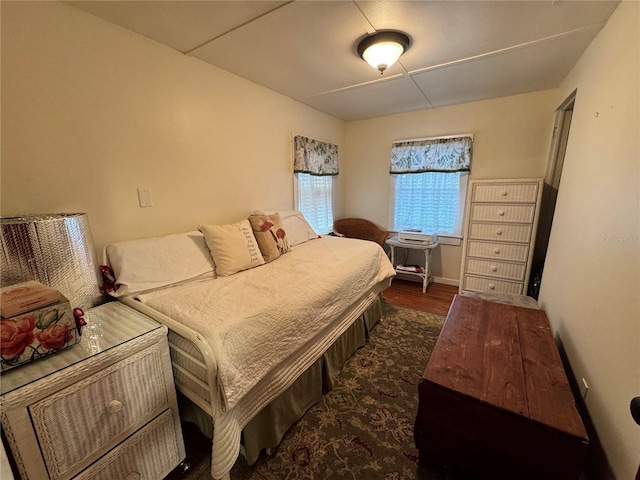 bedroom with dark hardwood / wood-style floors