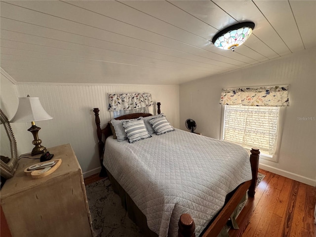 bedroom with hardwood / wood-style flooring and vaulted ceiling