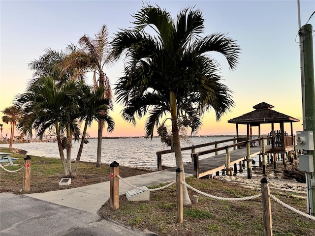 view of dock featuring a gazebo and a water view