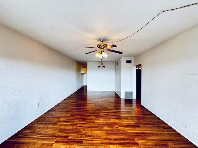 unfurnished room with ceiling fan and dark wood-type flooring