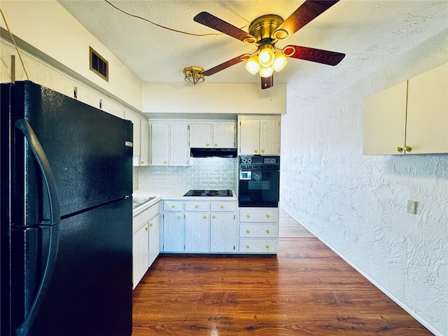 kitchen with ceiling fan, dark hardwood / wood-style floors, a textured ceiling, decorative backsplash, and black appliances