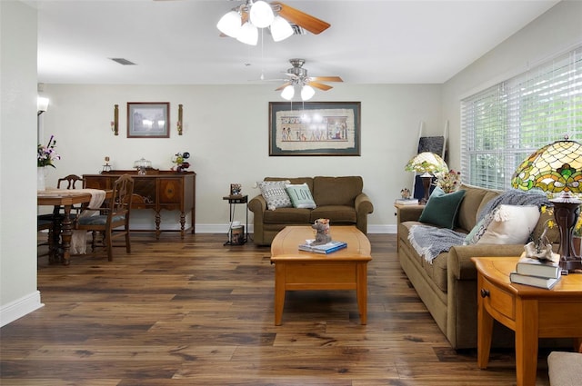 living room with ceiling fan and dark wood-type flooring