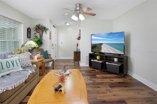 living room featuring ceiling fan and dark hardwood / wood-style flooring