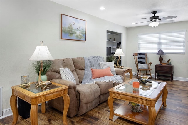 living room featuring ceiling fan and dark hardwood / wood-style flooring