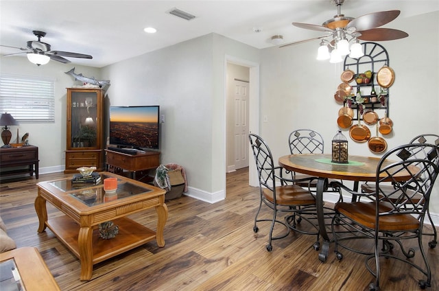 dining space featuring ceiling fan and wood-type flooring