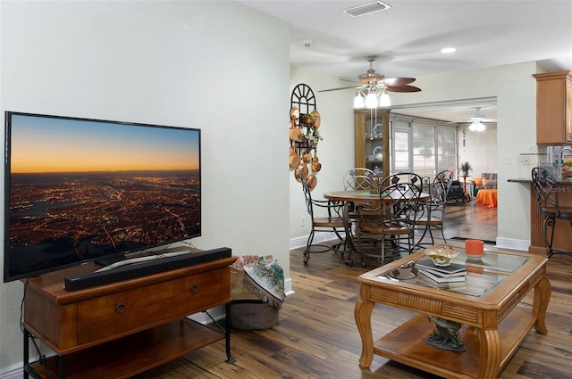 living room featuring ceiling fan and wood-type flooring