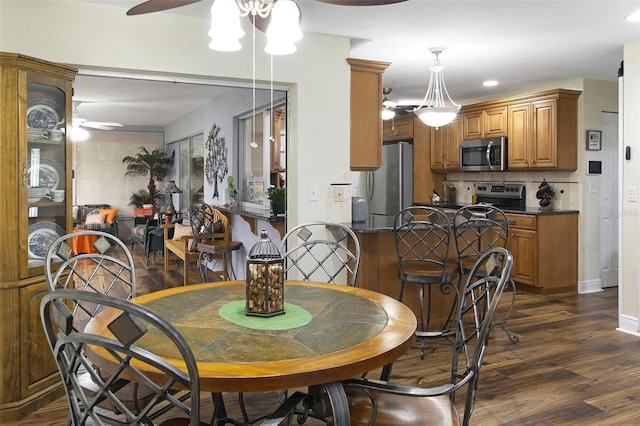 dining room featuring ceiling fan and dark hardwood / wood-style floors