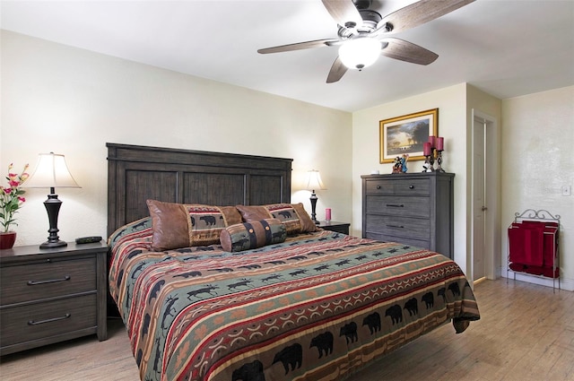 bedroom with ceiling fan and light hardwood / wood-style flooring