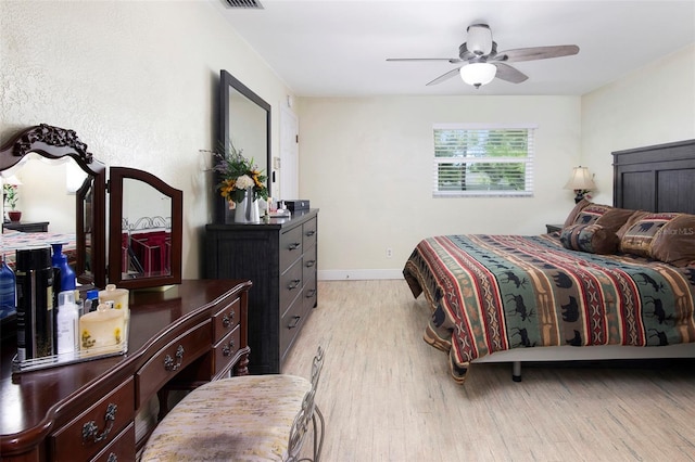 bedroom with ceiling fan and light wood-type flooring