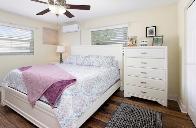 bedroom with a wall mounted AC, ceiling fan, multiple windows, and dark hardwood / wood-style floors