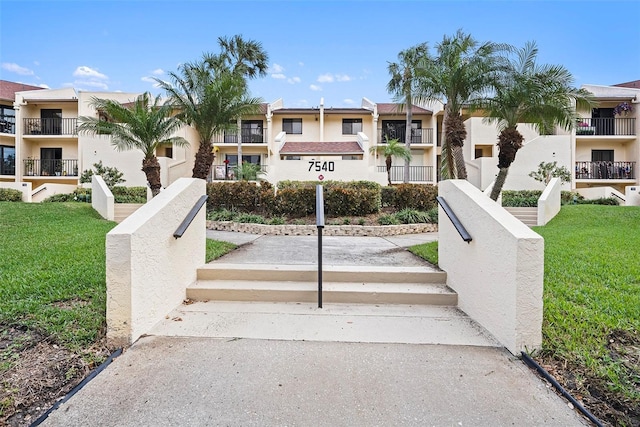 view of home's community with a yard