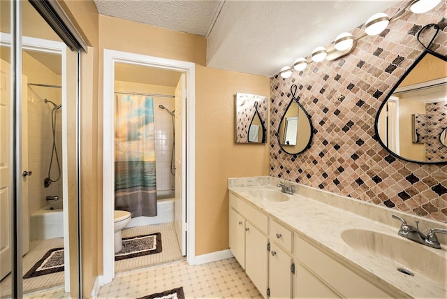 full bathroom with toilet, a textured ceiling, vanity, shower / bath combo, and tile patterned flooring