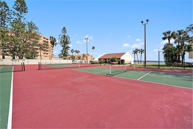 view of tennis court with basketball hoop