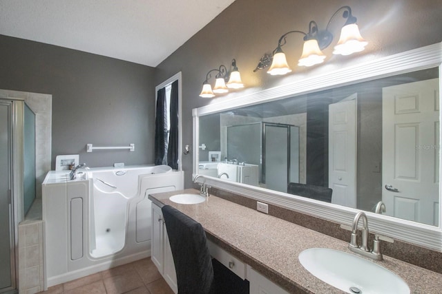 bathroom featuring tile patterned floors, separate shower and tub, and vanity