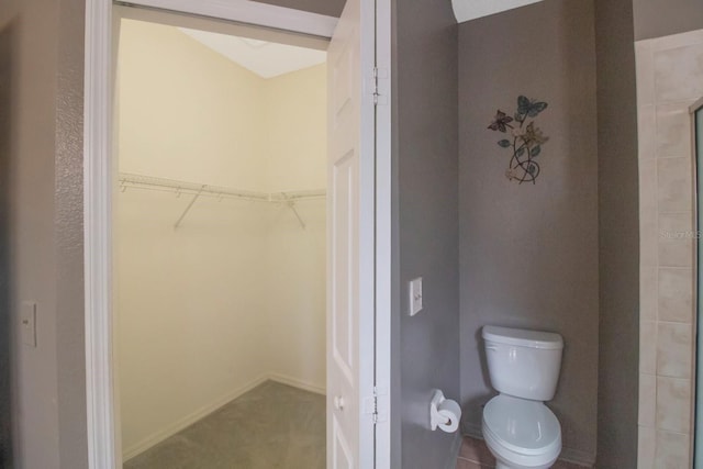 bathroom with toilet and walk in shower