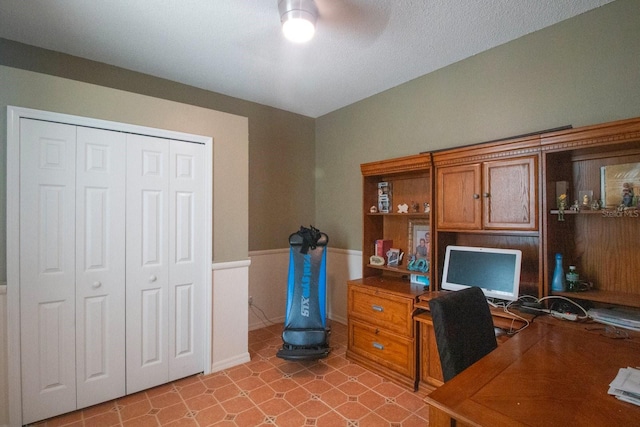 office space with a textured ceiling and ceiling fan