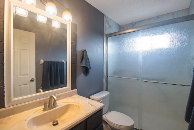 bathroom with vanity, toilet, and a shower with door