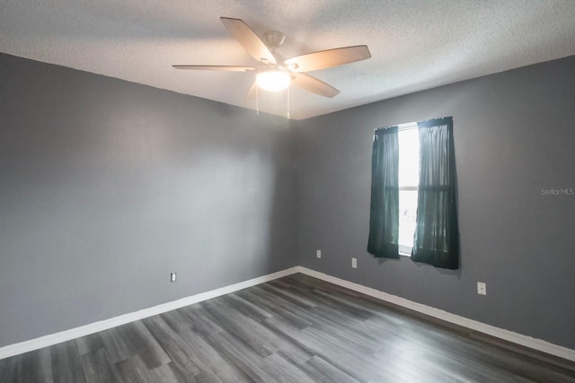 spare room featuring a textured ceiling, dark hardwood / wood-style floors, and ceiling fan