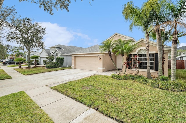 view of front of house featuring a garage and a front lawn