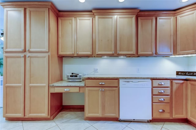 kitchen with light stone counters, light tile patterned flooring, white dishwasher, and built in study area