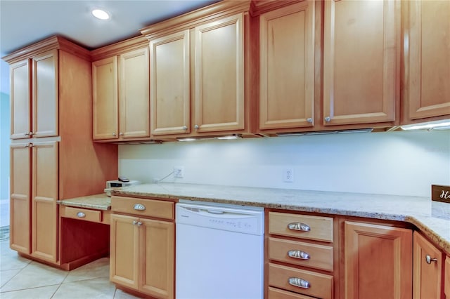 kitchen with dishwasher, light stone counters, light tile patterned floors, and recessed lighting