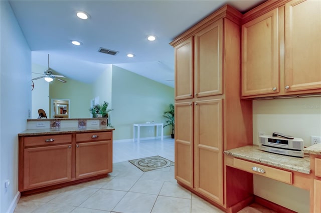 kitchen with visible vents, ceiling fan, vaulted ceiling, light stone counters, and recessed lighting