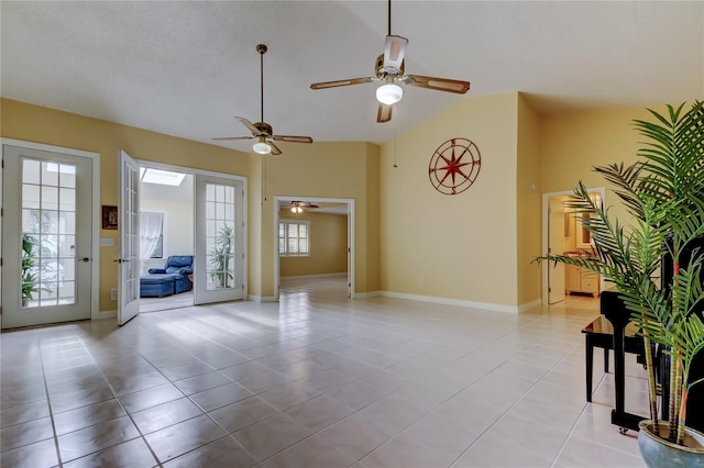 interior space featuring light tile patterned flooring, high vaulted ceiling, and baseboards