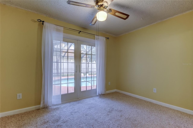 spare room featuring french doors, baseboards, a textured ceiling, and carpet flooring