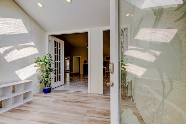 interior space with wood finished floors, recessed lighting, and french doors