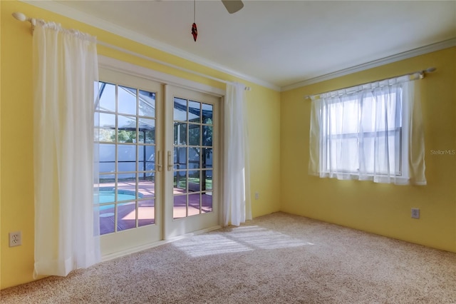 carpeted empty room with crown molding and ceiling fan