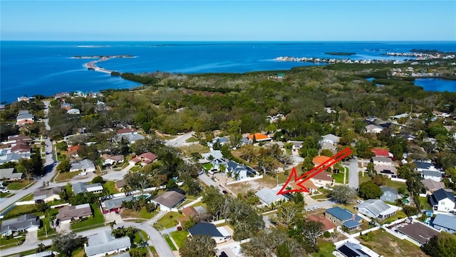 drone / aerial view with a residential view and a water view