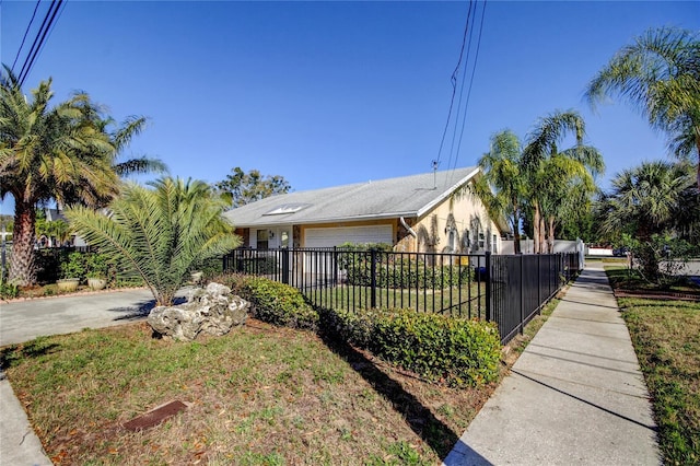 view of home's exterior featuring a fenced front yard and concrete driveway